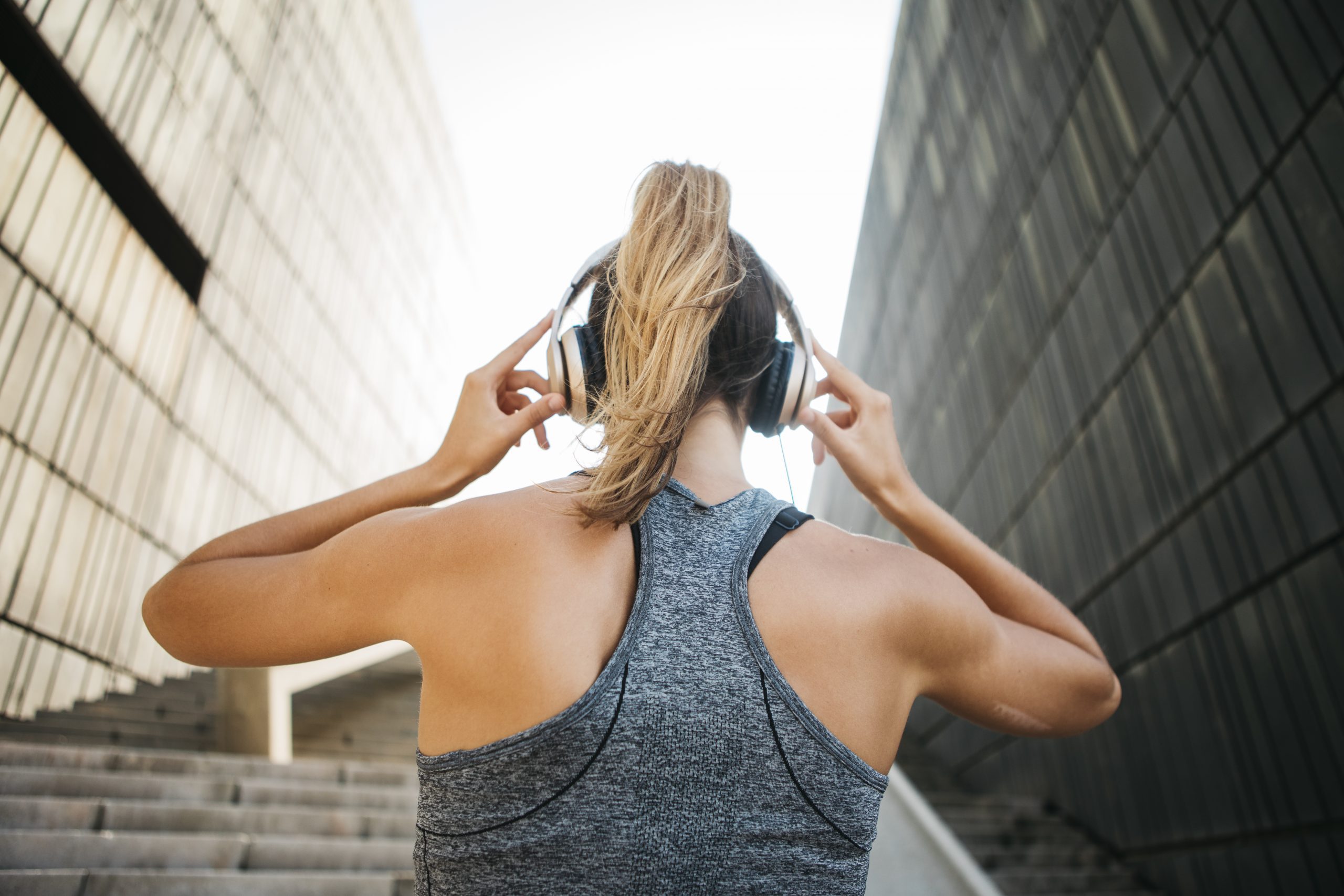 sporty-woman-with-headphones-in-urban-environment